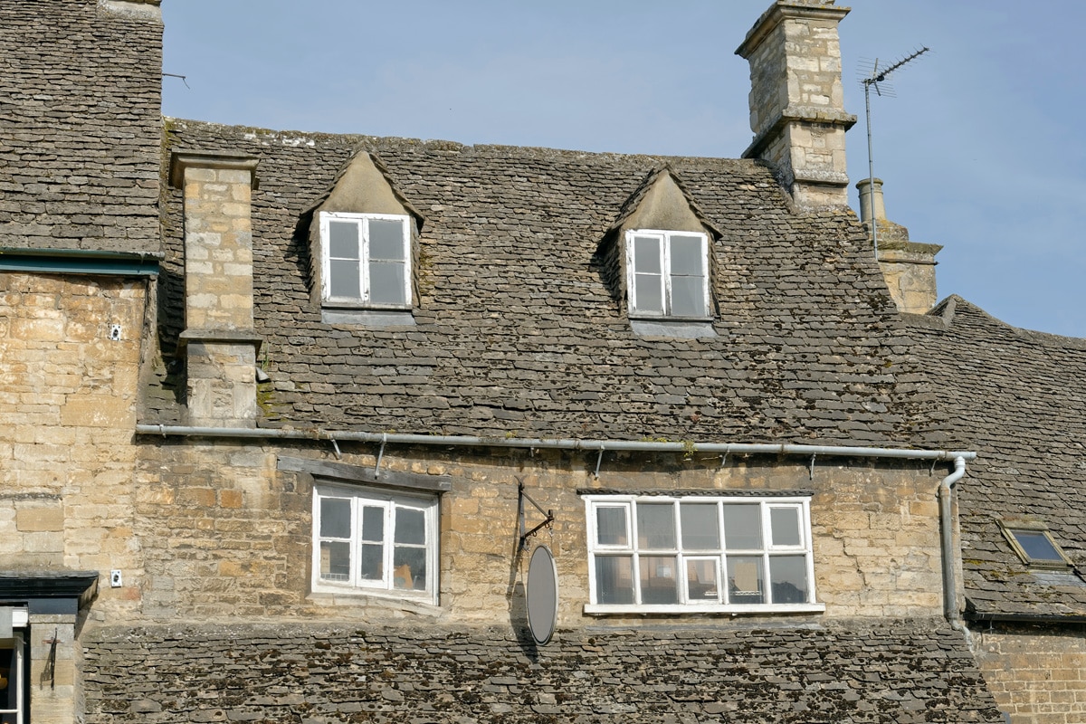 Subsidence damage visibile by the shape of the windows on an old house in the Cotswolds.