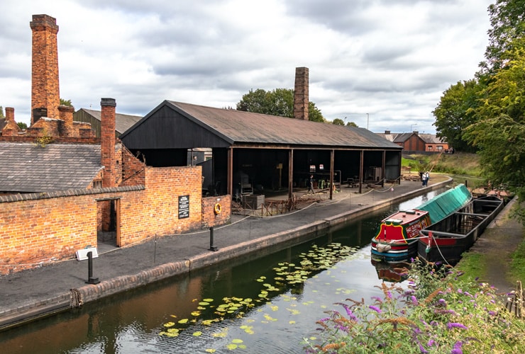 A narrowboat on the canal, running through the the Black Country Living Museum.