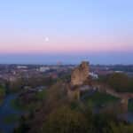 An aerial view of Dudley town centre as the sun goes down. Dudley Castle is visible in the foreground.