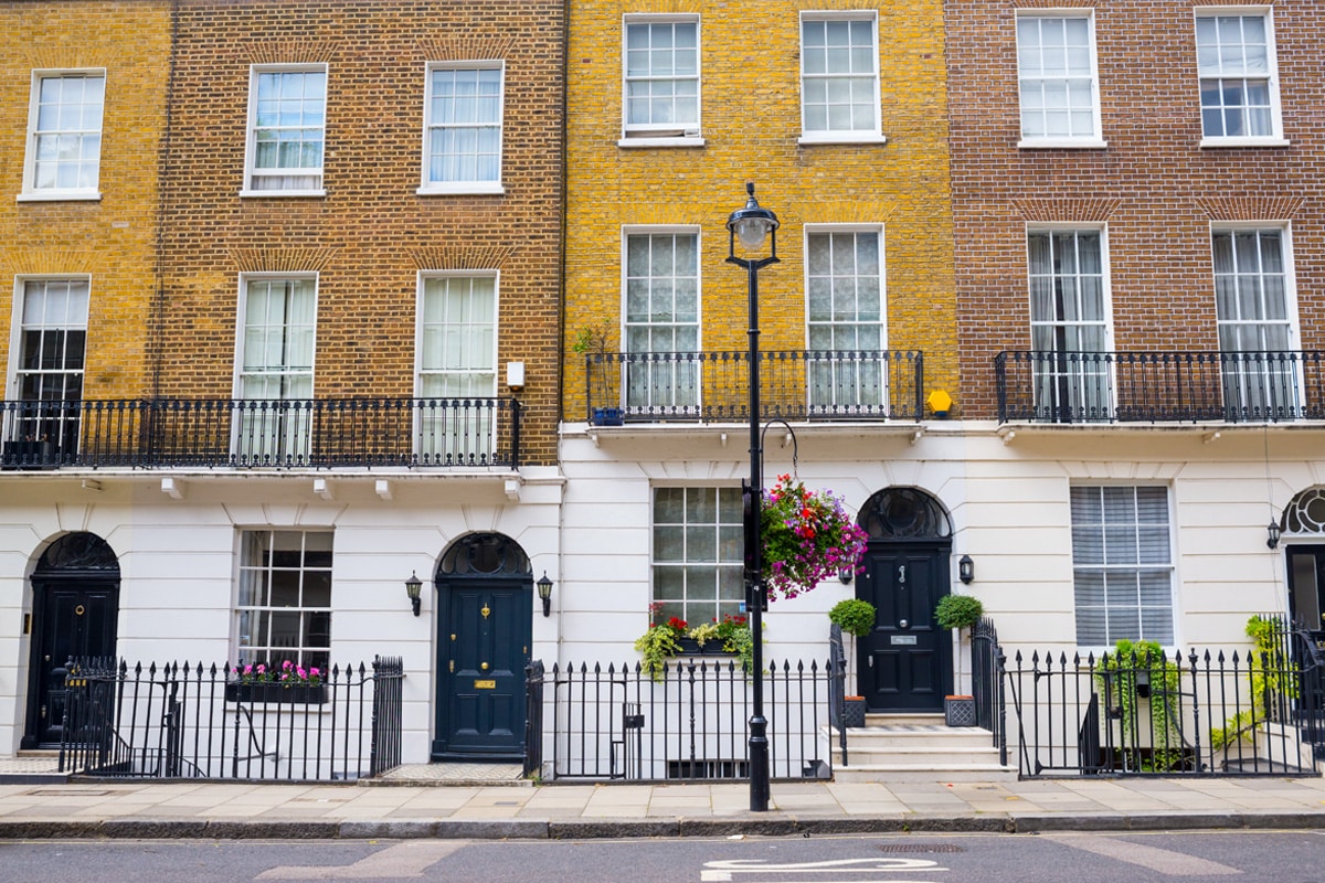 Facade of Georgian residential town houses made in yellow and red brick in a luxury residential area of West London.