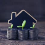 stacked-coins-wooden-house-model