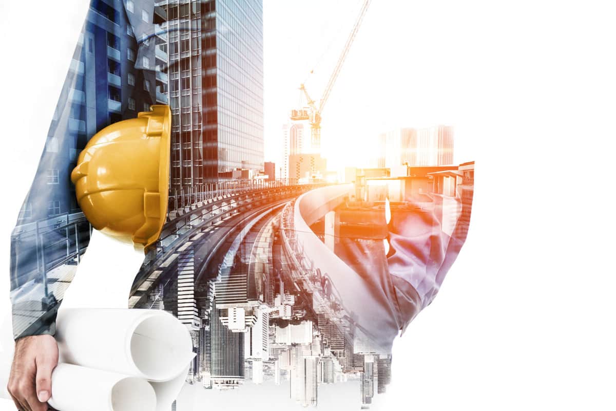 Double exposure image of construction worker holding safety helmet and construction drawing against the background of a construction site.