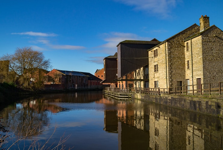 Old buildings on the side of the Leeds/ Liverpool Canal in Wigan.