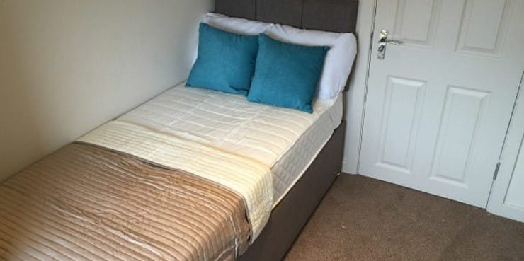 A single bed in the bedroom of an HMO.