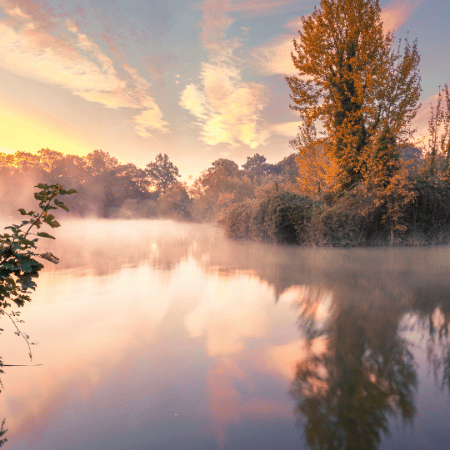 Mist hangs over the lake in Abington Park, Northampton.