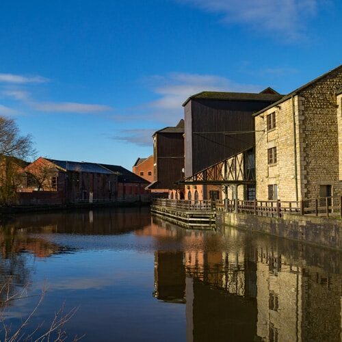 Old buildings on the side of the Leeds/ Liverpool Canal in Wigan.